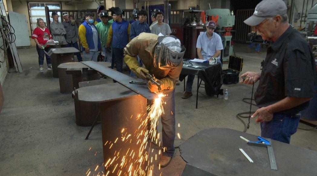 A student learning a skilled trade through hands-on training